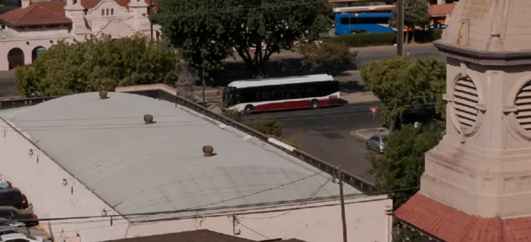 About image - a bus driving down a street