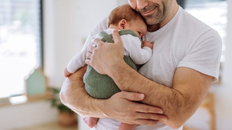 Father holding newborn child