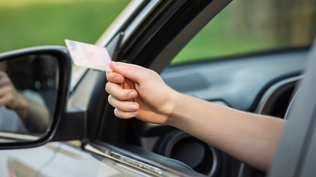 person handing over their license