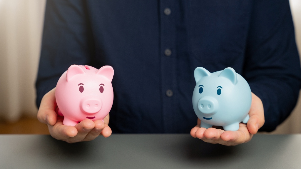 a man holds two piggy banks in his hands