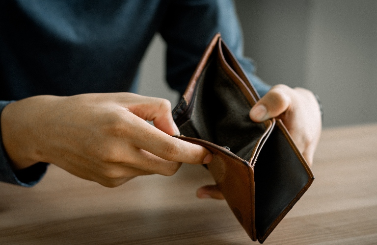 empty wallet in the hands of a man